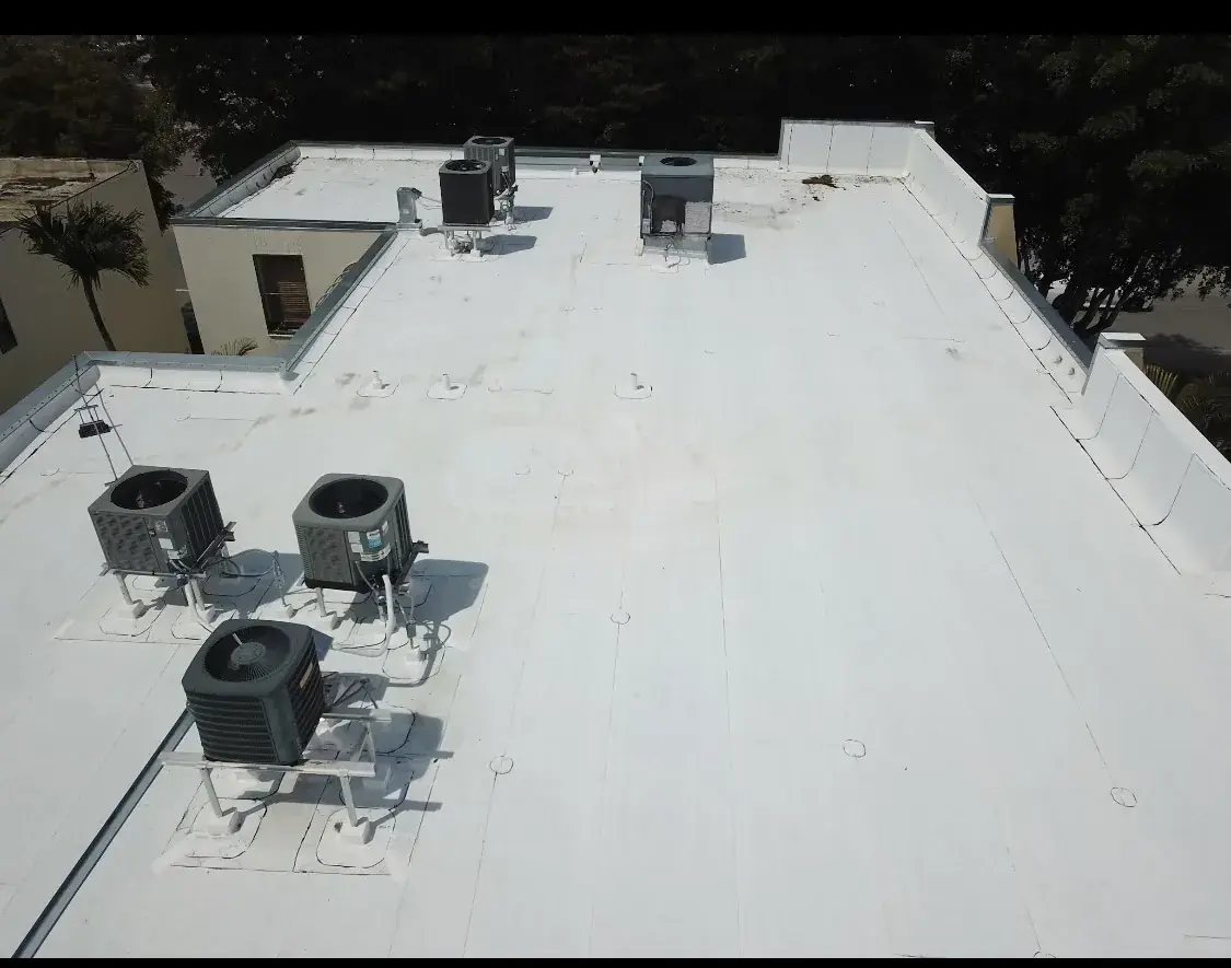 Completed white single-ply roof with rooftop HVAC, seen from above