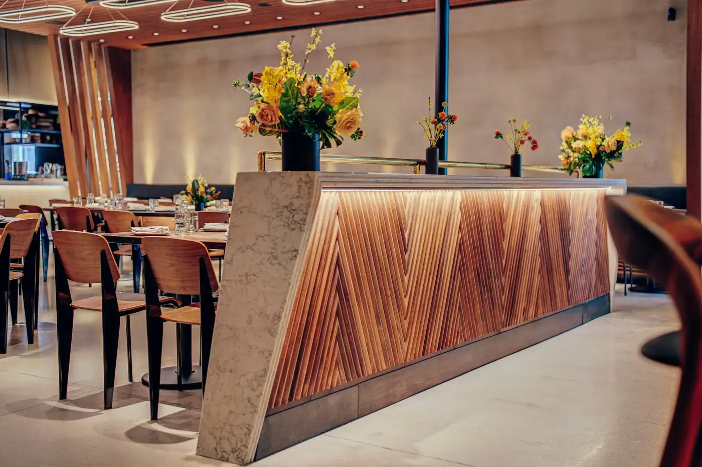 Tambour wood bar face meeting the marble end panel