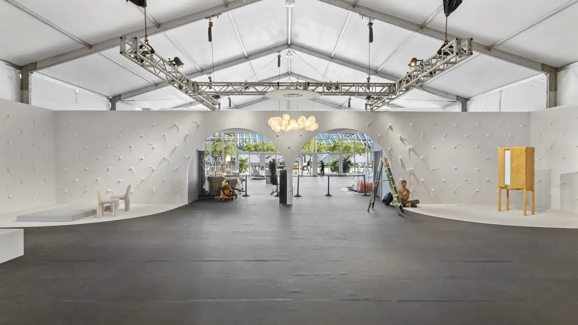 Design Miami fair hall with curved white walls and an arched entry