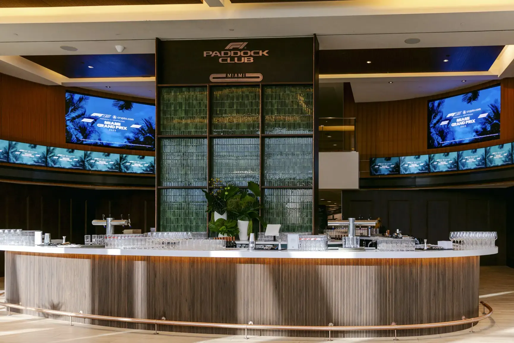 Paddock Club bar with fluted wood base, green tile wall, and marble counter
