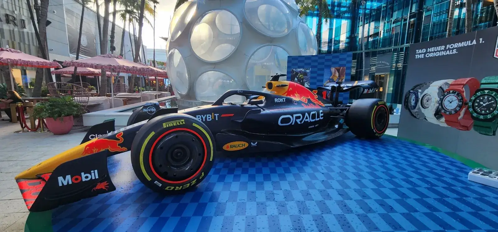 Formula 1 show car on the checkered platform, with the geodesic dome and the TAG Heuer watch display wall behind